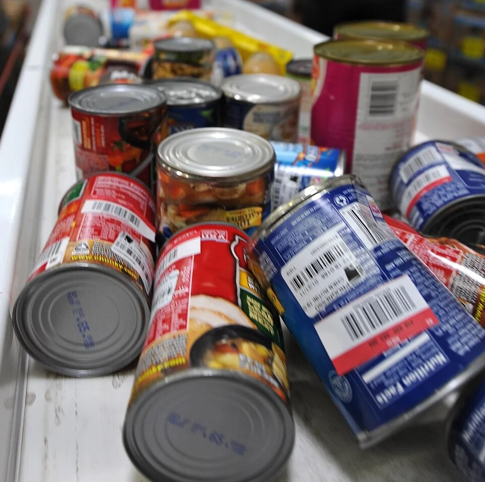 A photograph of canned goods, donated to a food bank.
