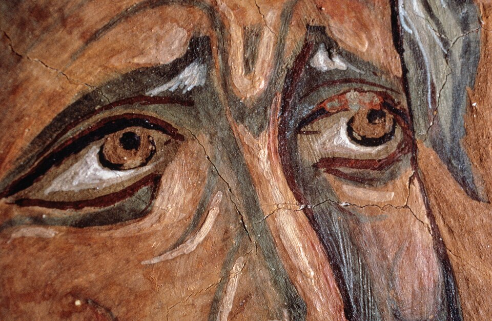 A detail from a painting of the prophet Ezekiel, zooming in tightly on his eyes, which appear to be looking upward. To the side, you can catch a glimpse of long gray hair.